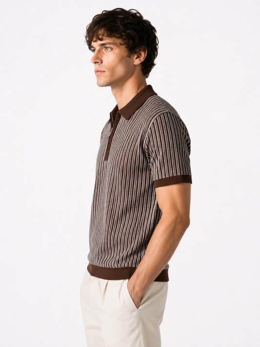 A man in side profile wearing a brown and beige vertically striped short-sleeve knit polo shirt with solid brown ribbed trim, paired with off-white trousers, against a plain white studio background.