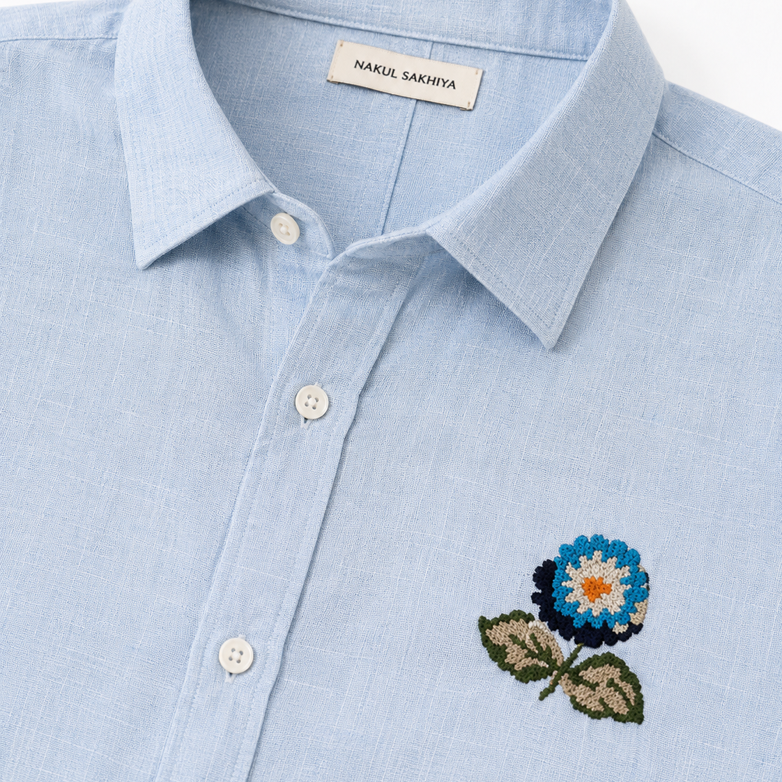 Premium sky blue embroidered linen shirt detail with floral embroidery by Nakul Sakhiya