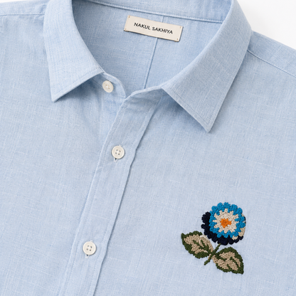 Premium sky blue embroidered linen shirt detail with floral embroidery by Nakul Sakhiya