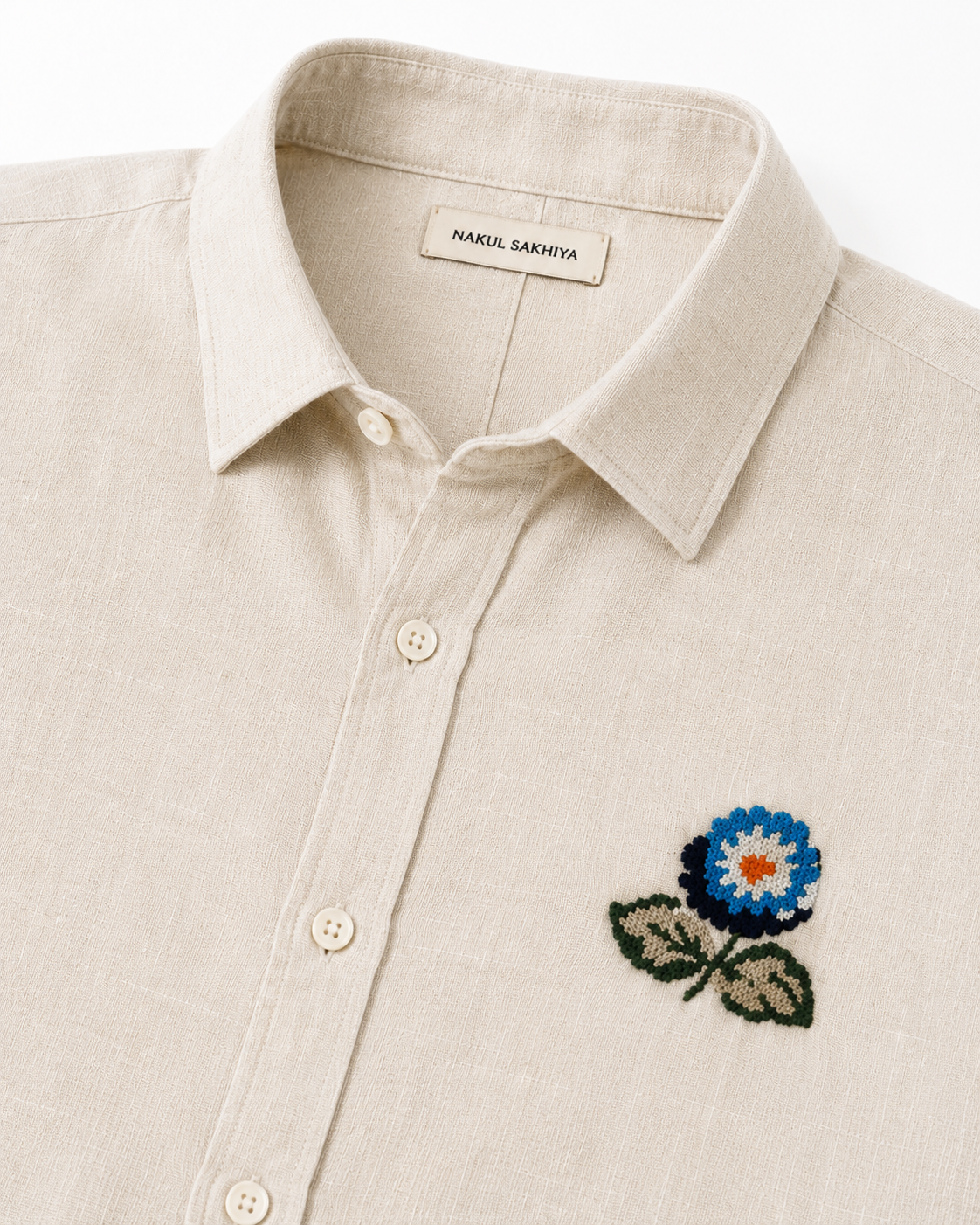 Floral embroidery detail on premium beige linen shirt for men