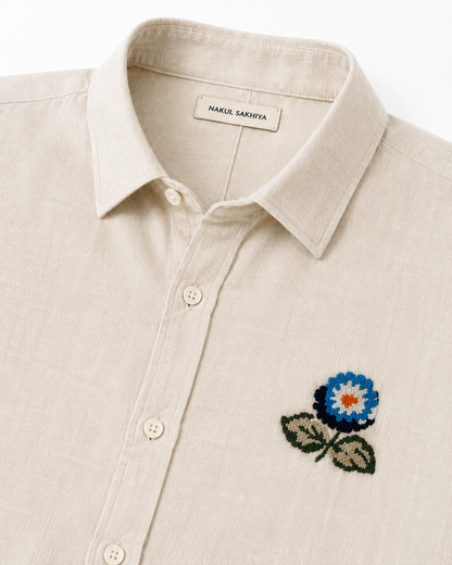 Floral embroidery detail on premium beige linen shirt for men