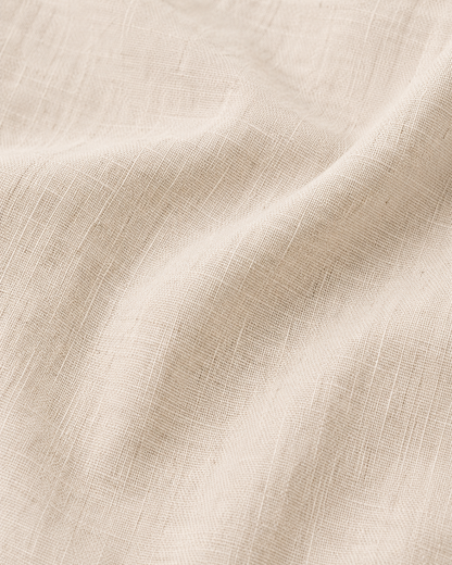 Premium beige linen fabric texture close up showing natural weave