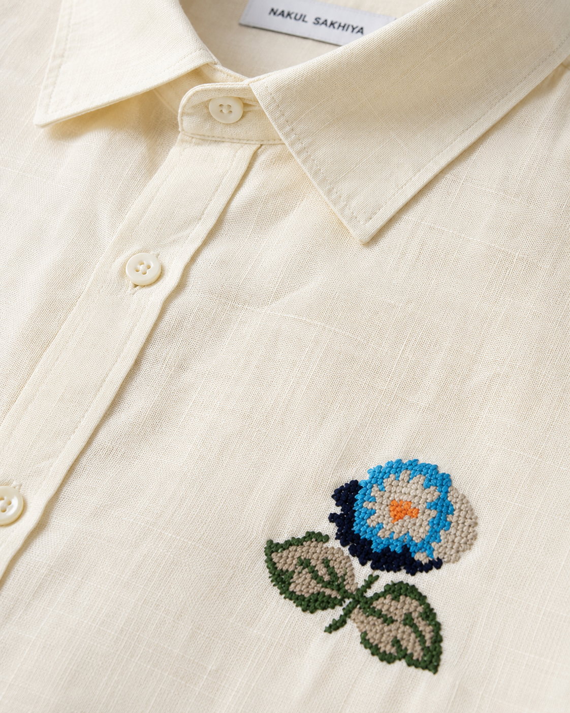 Floral embroidery detail on premium butter yellow linen shirt for men