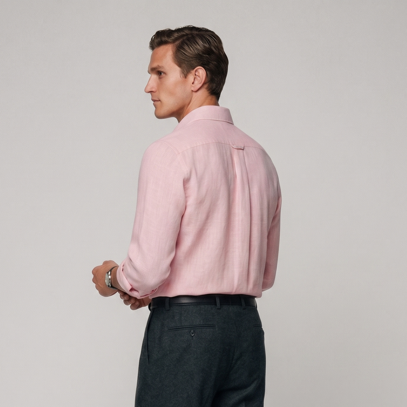 Side profile of male model wearing baby pink linen shirt