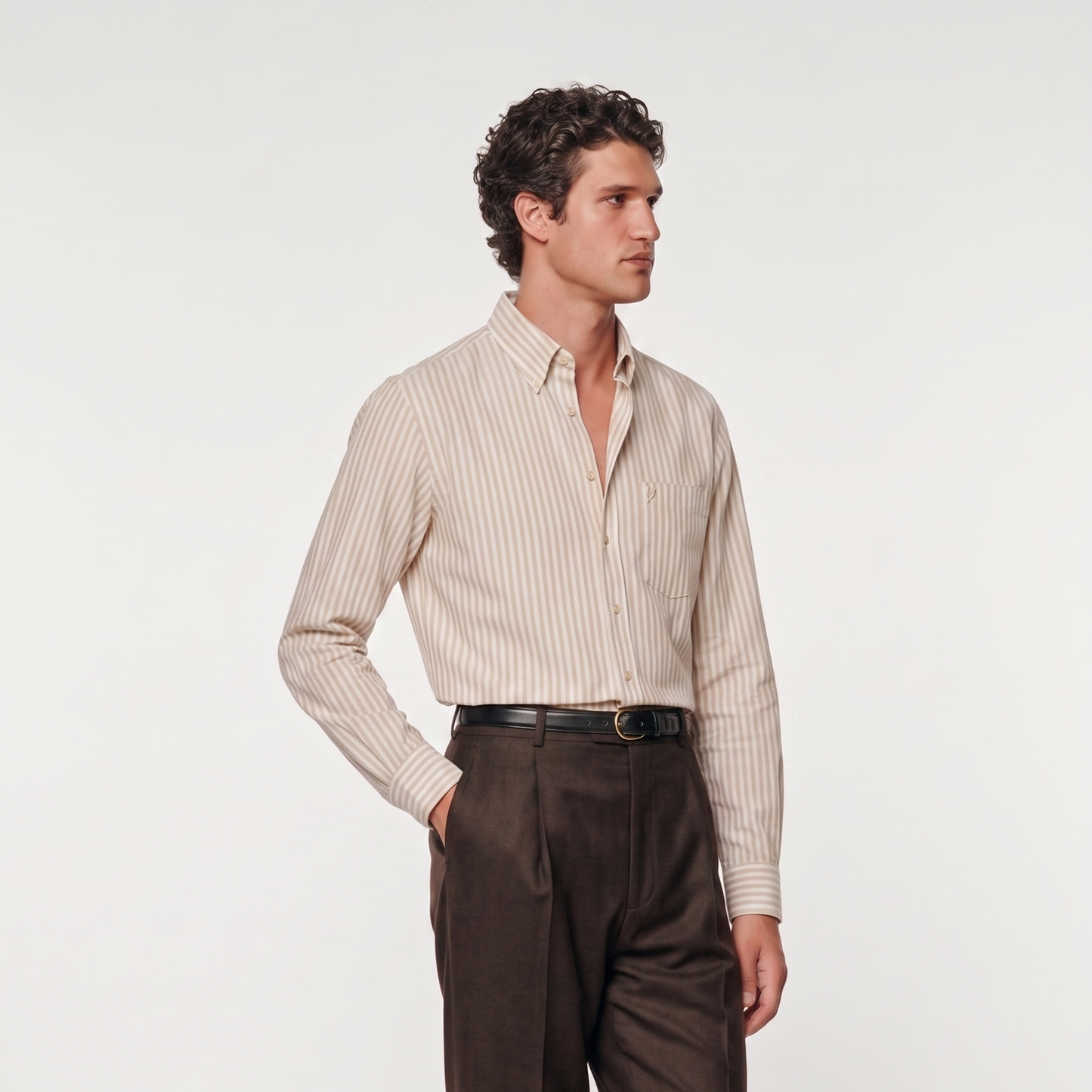 Side profile of male model wearing classic beige striped Oxford shirt