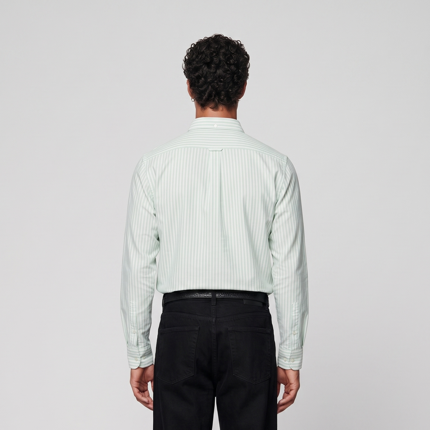 Back view of male model wearing mint green striped Oxford shirt