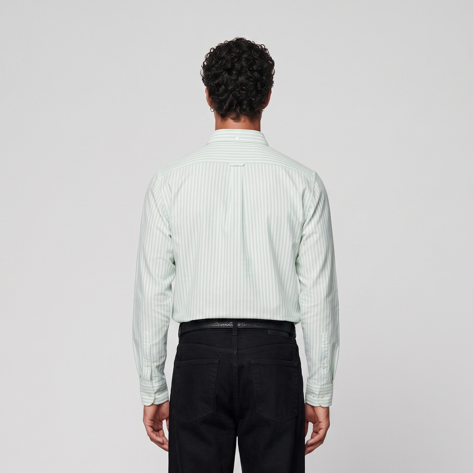 Back view of male model wearing mint green striped Oxford shirt