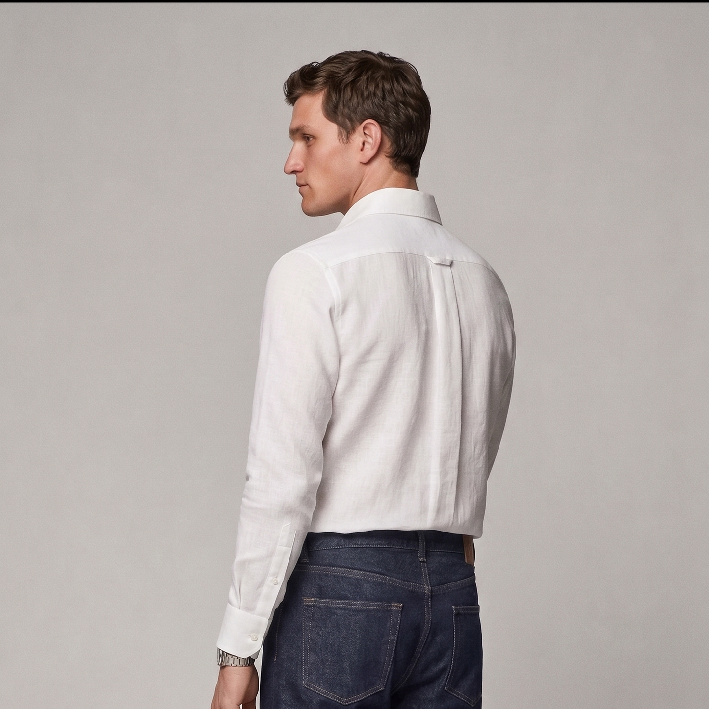 Side profile of male model wearing white linen shirt